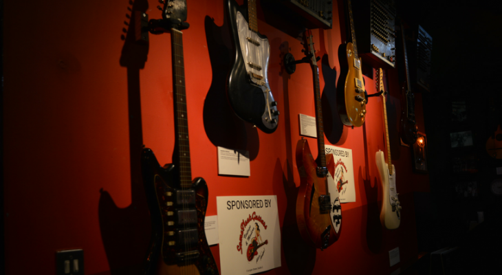 Background-picture-in-RockNRoll-museum-Guitars-on-the-wall1